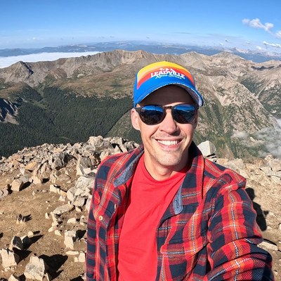 Wes smiling on a Colorado mountain summit.
